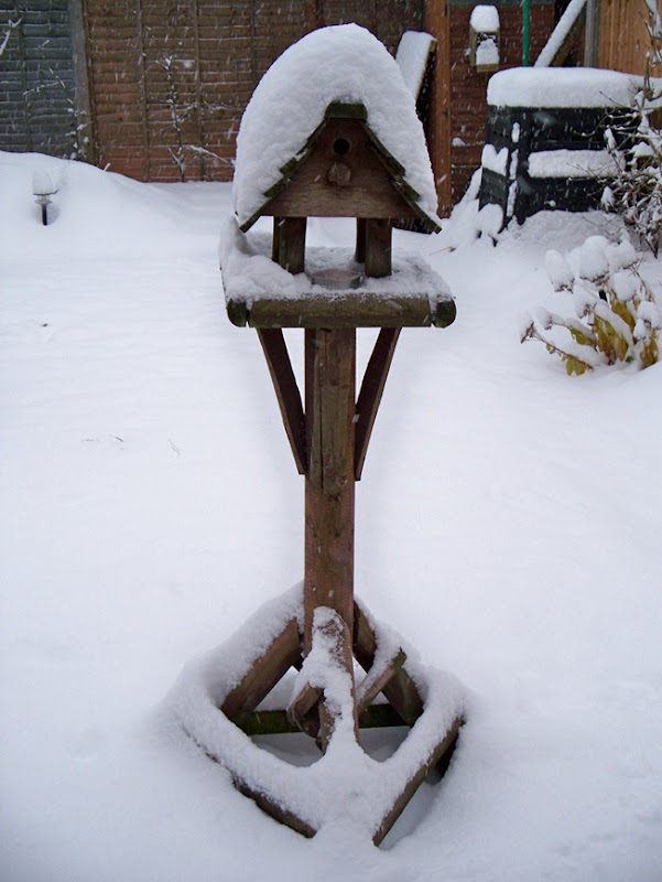 Buried bird table - in snow white landscape