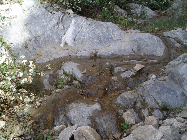 Rocks covered in a thin layer of flowing water.