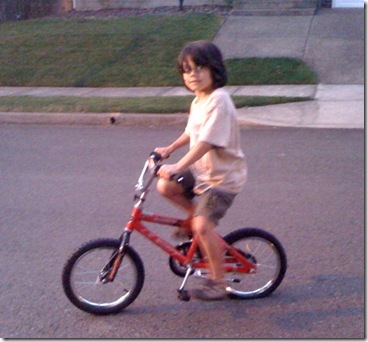 Giant boy on a teensy bike