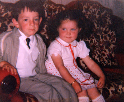 me aged seven in my communion suit looking sad