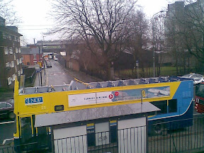 photo shows Dublin Bus parked beside railings with Fire engine parked behind. The top of the bus is completely gone, you can actually count all the seats upstairs.