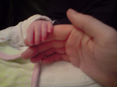 picture of a baby's hands over my first finger. The difference in size is as you'd expect - big man hands and tiny baby fingers.