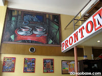 Coffee shop paintings hang inside Pronto Mario