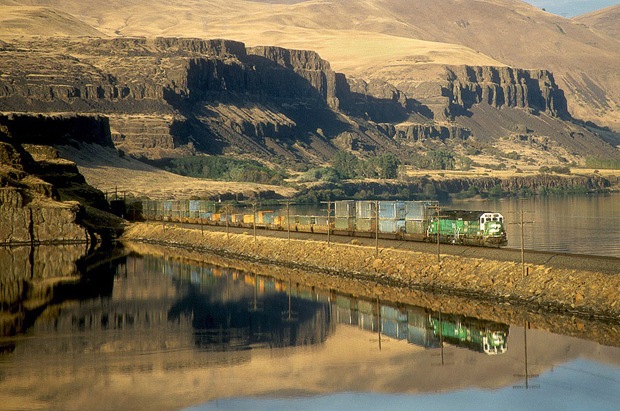The last light of day sees an empty garbage train heading West along the Columbia River in North Dalles, Washington. 