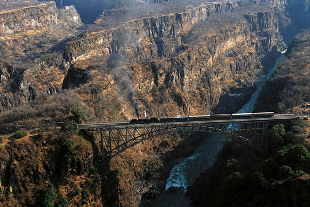 Train runs over a bridge through an amazing landscape at ZimbabweVictoria Falls 