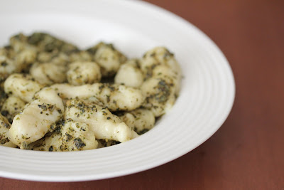 photo of a bowl of gnocchi tossed with pesto