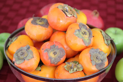 fresh persimmons in a bowl.