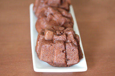 close-up photo of chocolate cakelets lined up on a plate