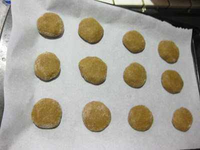 photo of the cookie dough balls on a baking sheet lined with parchment