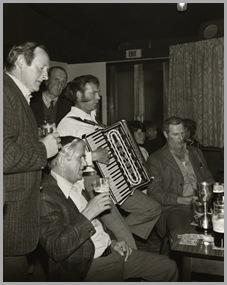 The Danby and District League Open Quoits Championship.
Winner John White (right) celebrating, accompanied by Ed White on the piano accordion.
The League championship was held during '79 at the Rifle Club Ground, Whitby.  Whitby Rifle Club, on the west side of Whitby, has a splendid rifle range as well as 3 outdoor quoit grounds and 2 indoor grounds.
The indoor grounds allow a winter quoit league of nine five-a-side teams to thrive.