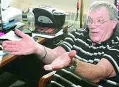 UMD professor Ron Marchese uses his hands to illustrate how the ground was sloped in one area over an ancient Greek city, indicating that the spot may have been a theater. Marchese and his team spent 12 years producing a detailed map of the city, using technology that doesn’t require digging. 