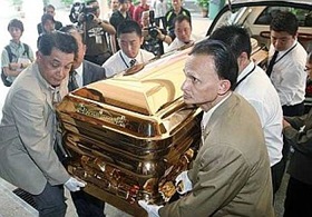 Datuk Ibrahim Ismail (front right) helping to lift the 14-carat gold-plated Chinese coffin worth RM388,800 into the museum