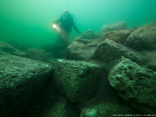 A diver inspects limestone blocks that form part of the ruins of the Temple of Isis on the royal island of Antirhodos