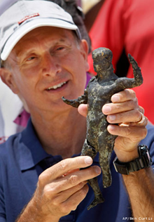 French underwater archaeologist Franck Goddio shows a recently excavated bronze cult statue found in the Temple of Isis, onboard the Princess Duda research boat
