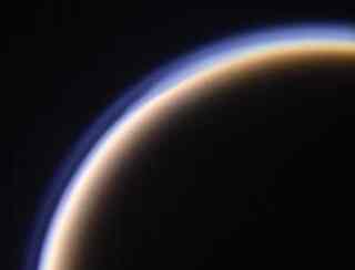 Laboratory simulations suggest that organic aerosols on Saturn's moon Titan (pictured) are fractal shaped. Fluffy fractal molecules may have blanketed the early Earth, explaining how it stayed warm (Image: NASA/JPL)