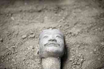 The head of a newly found terracotta warrior is placed at the excavation site inside the No. 1 pit of the Museum of Qin Terracotta Warriors and Horses, on the outskirts of Xi'an, Shaanxi province.