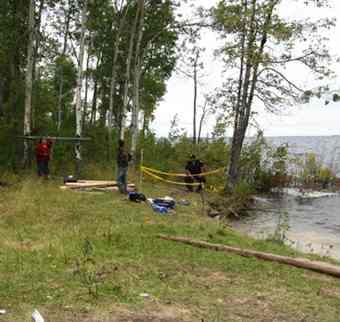 The site where the man was buried. Chief Donny Morris, Darryl Sainnawap and Const. Barry McKay monitor the coroner's investigation into the burial. It was determined that the remains were ancient.