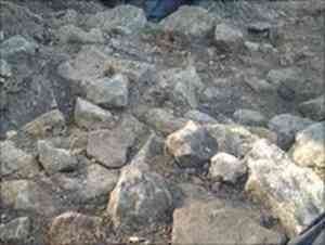 The previously unearthed corner of a stone building at the mount