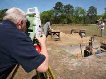 Graduate student Kevin Chapman surveys the site at Camp Lawton while students dig a trench in search of artefacts