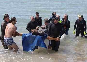 Volunteer scuba divers salvage parts of the ancient Greek shipwreck near Ancient Greek colony of Gela