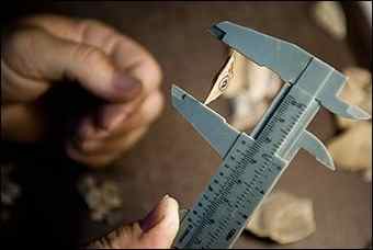 Israeli archaeology Prof. Ran Barkai uses a ruler to display a stone believed by researchers to be one of the world's oldest known disposable knives, at the Tel Aviv University, Israel, Monday, Aug. 30, 2010. Israeli archaeologists believe they have discovered the world's oldest known disposable knives in a cave near Tel Aviv.Dating to the Stone Age, the sharp pieces of flint are believed to be at least 200,000 years old.