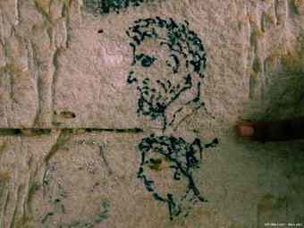 Unearthed graffiti is seen on a stone wall inside a tomb at the ancient city of Leukaspis.