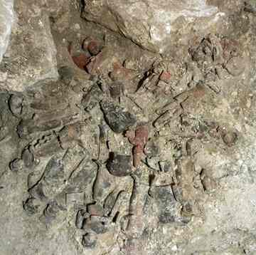 A falling slab of stone from the tomb's roof crushed 23 figurines that had been arranged to depict a funeral ceremony. (Varinia Matute)