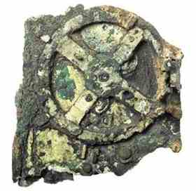 The largest surviving piece of the Antikythera mechanism contains some of its internal workings, including one of the major gearwheels and several smaller gears that have been crushed underneath.