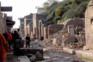 People standing by rubble of the collapsed house (AP Photo/Franco Castanò)