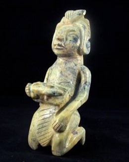 A malachite stone carved figure from Monte Alban in Mexico. [Photo: Deborah McCague / Shutterstock]