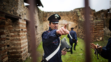 Policemen guard a Roman house after a wall collapsed on Dec. 1, 2010. It is one of the structures to crumble in the last month.