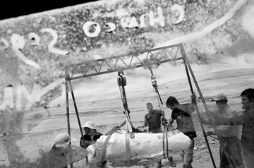 Members of an expedition used a makeshift crane to lift the fossilized skull of an ancient whale. 