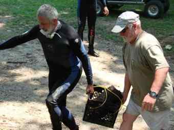 Underwater archaeologist Christopher Amer (left) and archaeological assistant Joe Beatty carry an artillery shell from a Confederate Brooke rifled cannon recovered from the Pee Dee River (Source: University of South Carolina)