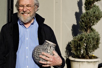 John Warnock of Los Altos, Calif., holds a an Anasazi jar he bought at the Bonhams and Butterfields auction house in San Francisco, Monday, Dec. 6, 2010. 