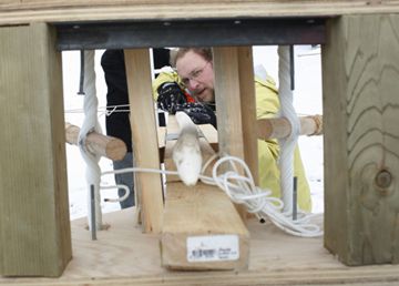 Kenyon College paleoanthropologist Bruce Hardy readies a replica Neanderthal spear in a launching device called a ballista.