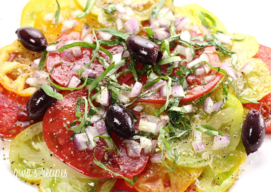A simple summer tomato salad made with heirloom tomatoes, kalamata olives, red onion, extra virgin olive oil and garden fresh basil. 