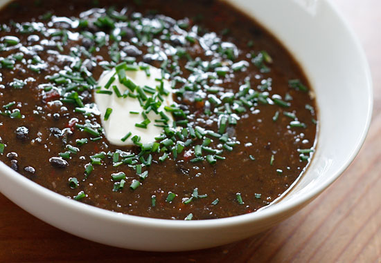 Black bean soup is a very hearty soup, super high in fiber, and so inexpensive to make. It's perfect topped with low fat sour cream and fresh chopped herbs such as chives, cilantro or scallions.