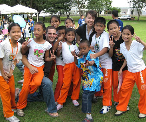 Up with People participants with children from the Leodegario Victorino Elementary School