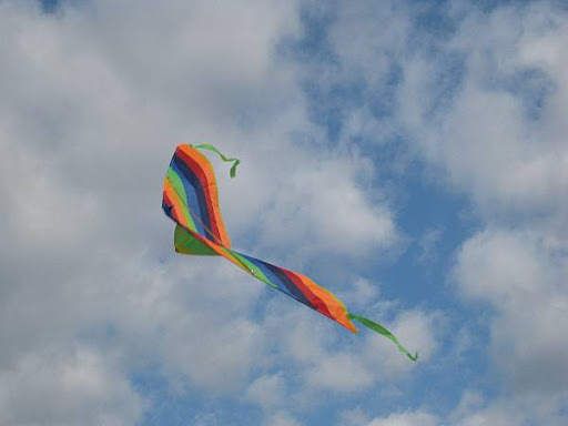 rainbow-colored kite in a blue sky
