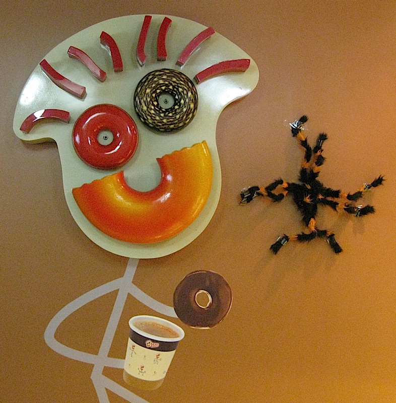 Go Nuts Donuts mascot with Halloween spider