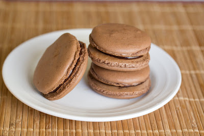 photo of chocolate macarons stacked on a plate