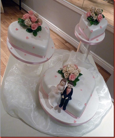 3-tier-tilting-cakes-with-rose-and-modeled-characters
