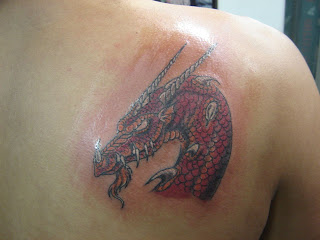 Red dragon's head tattooed on the back