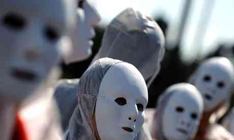 Protesters wearing masks during a proof in executive Athens, Greece