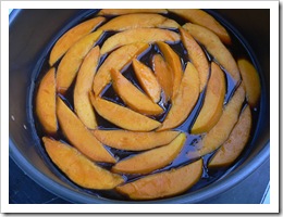 Slices of mango line the tin