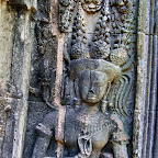 This Thommanon Devata (sacred female image) is also holding three mysterious rod-like objects with the "devata mudra." She is holding them with her left hand, and her stomach is unmarked (the previous devata holds them with her right hand and has a marked stomach). Siem Reap, Cambodia http://www.Devata.org