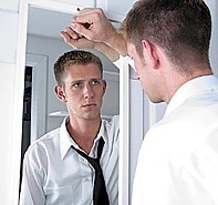 [Young man looking in mirror[22].jpg]