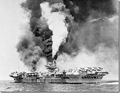 HMS Victorious on fire after being struck by three kamikazes at the Battle of Okinawa.  Planes could take off an hour later.