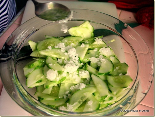 sprinkling sugar on cucumbers