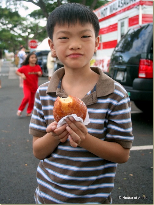 Daniel eating a malasada